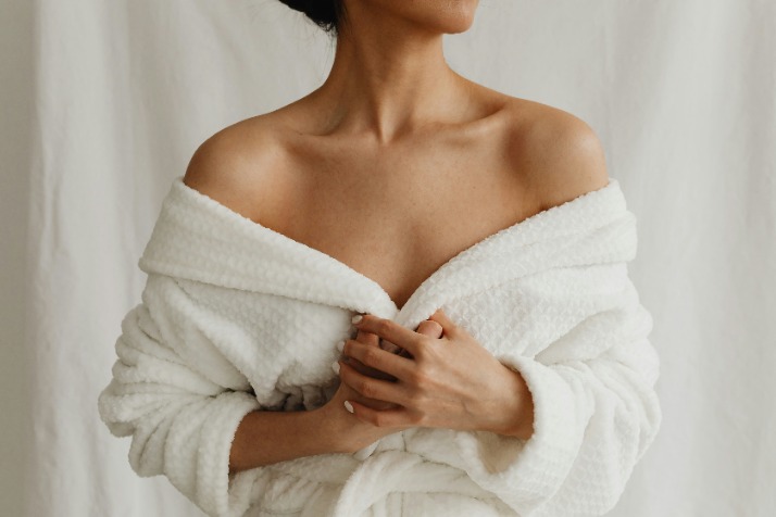 woman in white robe with exposed shoulders